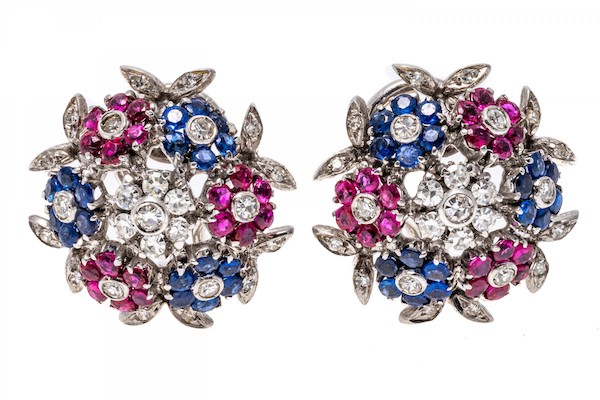 Charming dome style earrings feature alternating clusters of sapphires and rubies, with a cluster of diamonds set at the top and accenting the clusters. TCW of the diamonds approx 0.94, sapphires approx 1.11 and rubies approx 1.11.